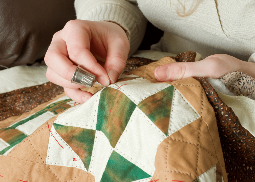 a woman using a thimble while quilting