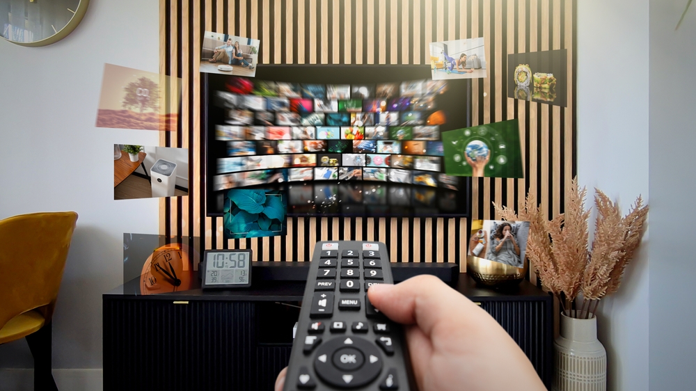 a remote clicking at a TV with many streaming services to choose from